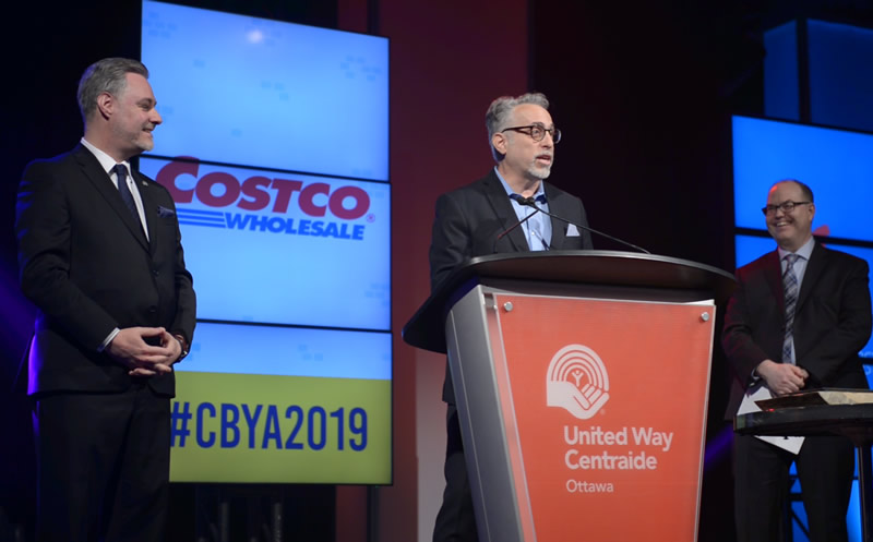 A photo of Costco representatives making a speech at the CBYA Gala.
