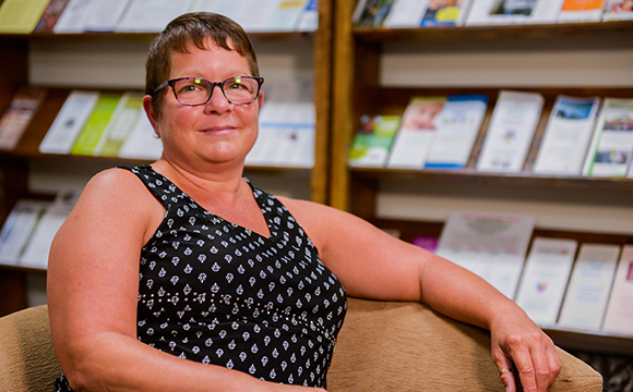 Julie_Renfrew County_Blog Thumb A photo of Julie sitting in a chair and smiling