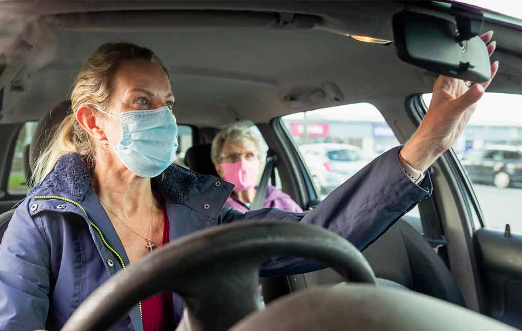 A caregiver driving a vulnerable senior to a doctors appointment.
